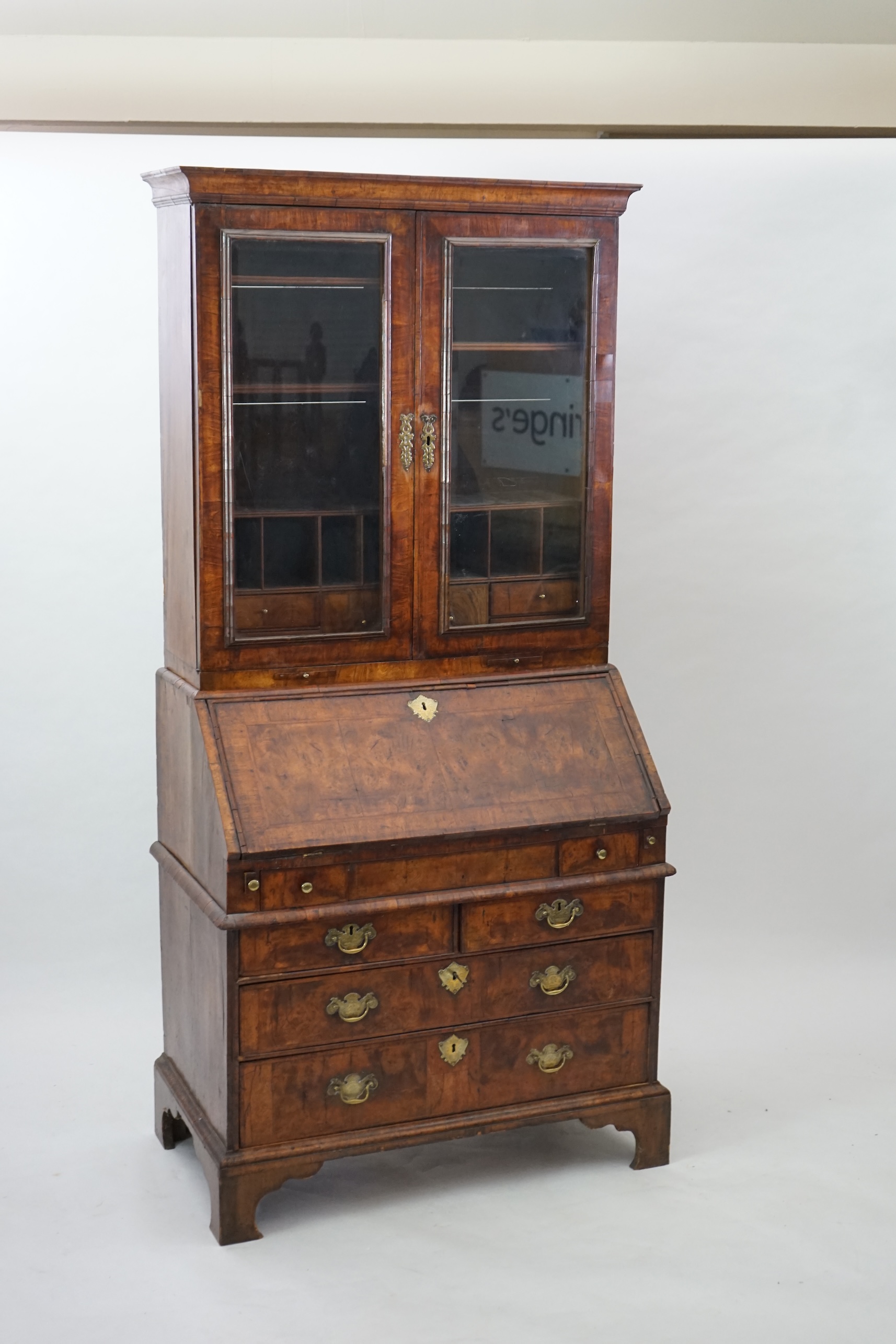 An early 18th century walnut bureau bookcase